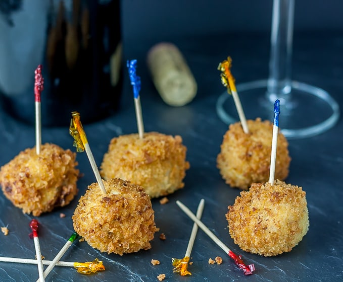 five croquettes with colored toothpicks 