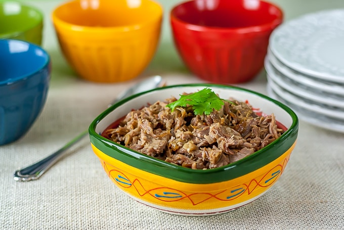 A bowl with pernil slow roasted Puerto Rican style pork.
