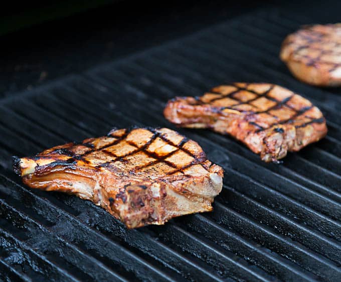 pork chops on the grill with grill marks 