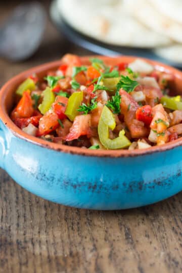 A blue bowl with Turkish ezme.