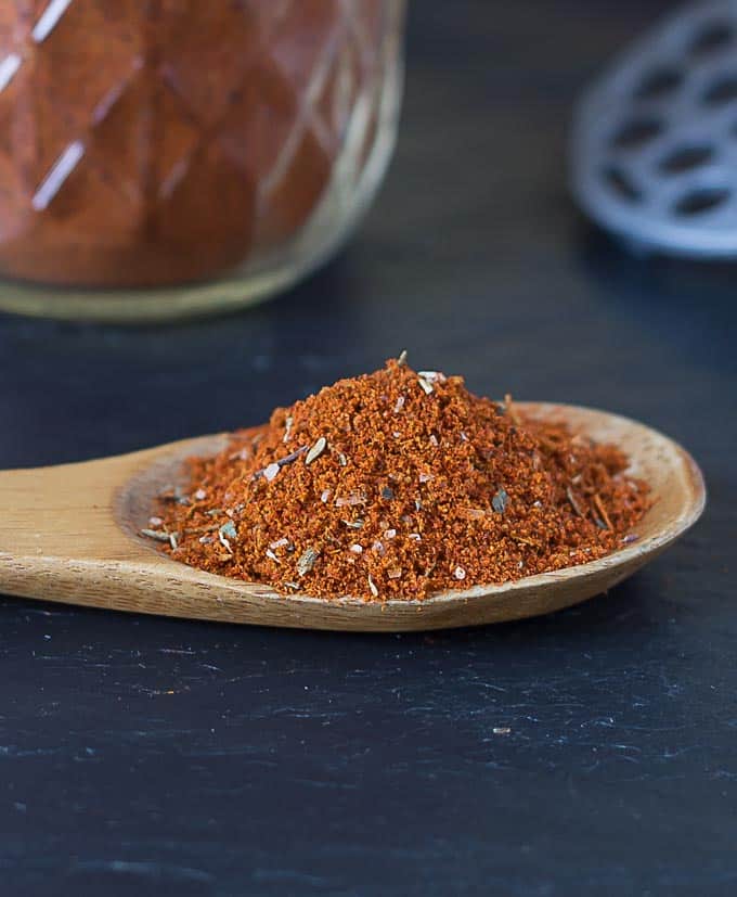 a close up spoon filled with chili powder