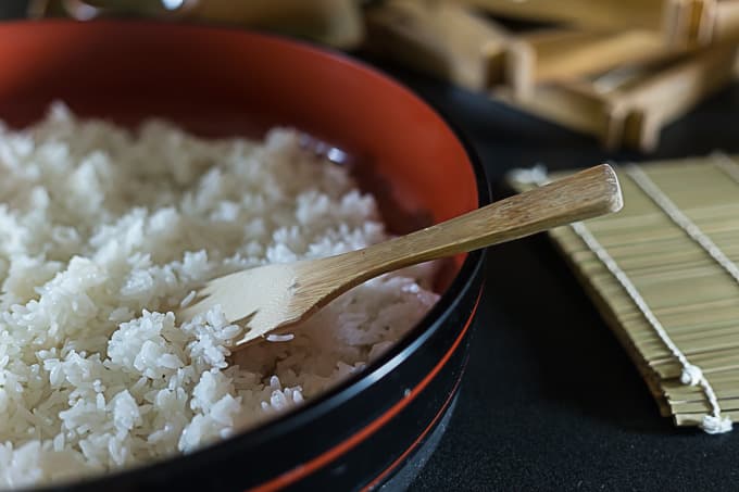 sticky rice for making sushi and a paddle in a bowl