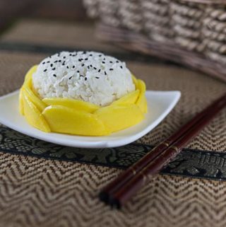 thai mango sticky rice on a plate with chopsticks