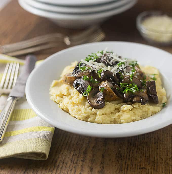 polenta with mushrooms and sausage in a bowl