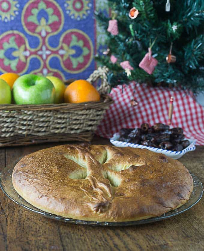 a closeup of French olive oil bread with a Christmas tree in the back