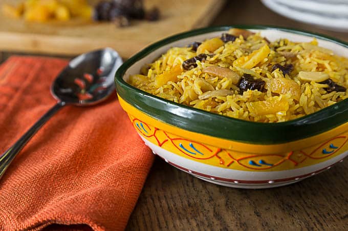 Fantastic flavors of sweet and savory basmati rice with almonds, apricots dates and sazon with saffron. A super simple dish with fantastic flavors! | ethnicspoon.com