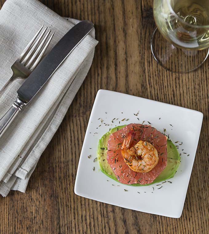 a top view of layered avocado, grapefruit, and shrimp