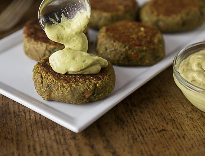 cooked lentil burgers on a plate with mustard 
