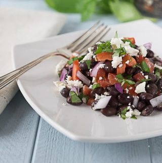 You will love this black bean, feta, basil, red onion and tomato salad. Try a great cool summer salad with bright herb flavors of basil and thyme. | ethnicspoon.com