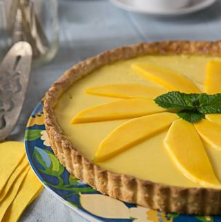 You will love the Tropical flavors in this mango passion fruit tart! Sweet, creamy and tangy are all the wonderful flavors that will delight you! Baked in a nice sweet crunchy shortcrust. | ethnicspoon.com