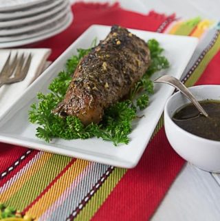 roasted pork loin on a plate with a red placemat