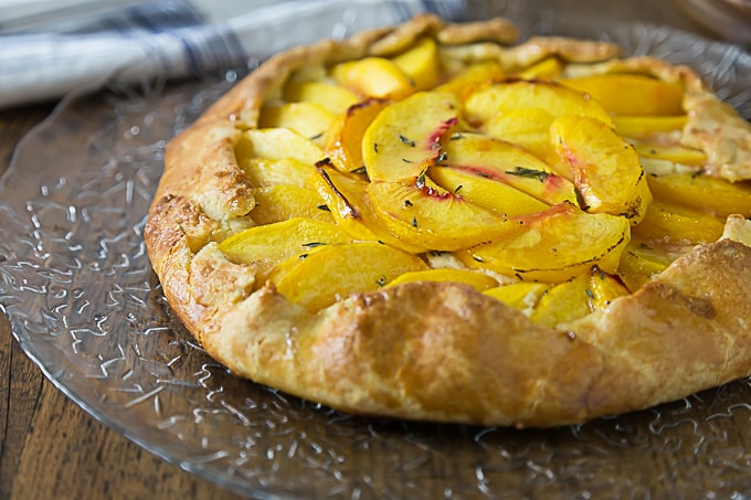 A rustic dessert that is simple to make! Fresh peach crostata with a creamy Neufchatel filling! It one of my favorite farm to table desserts! | ethnicspoon.com