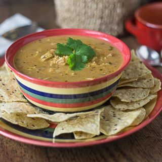 One of my favorite Mexican style soups. This is a super simple bowl of comfort food! Creamy chicken tortilla soup is cheesy, spicy and smooth to warm you on a cold day! | ethnicspoon.com