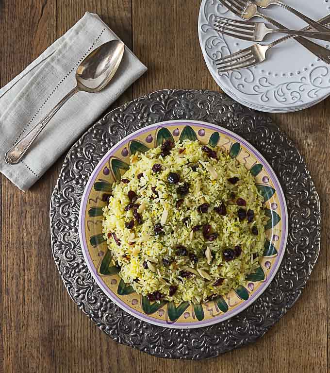 Try this delicious Persian style saffron rice with almonds and Craisins brings a contrast of flavors and textures. This is similar to the dish Albaloo Polow. | ethnicspoon.com