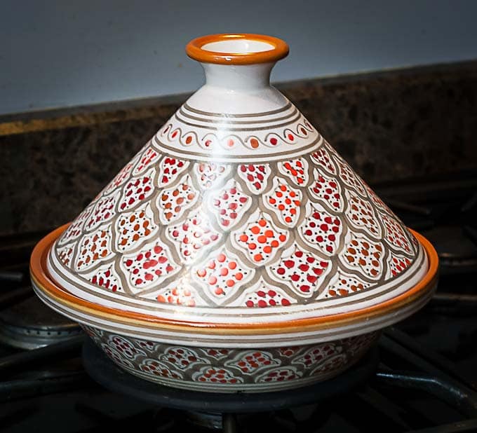 an orange and red tagine on the stove