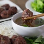 Bun cha is a traditional Vietnamese dish of grilled pork meatballs served with a delicious golden broth, a variety of fresh herbs, greens, and rice noodles. | ethnicspoon.com