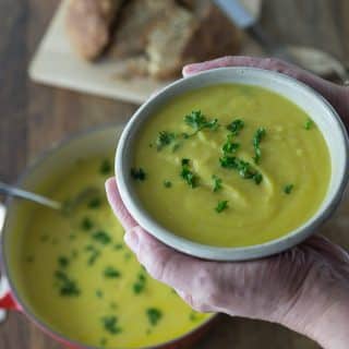 a bowl of cauliflower soup with parsley