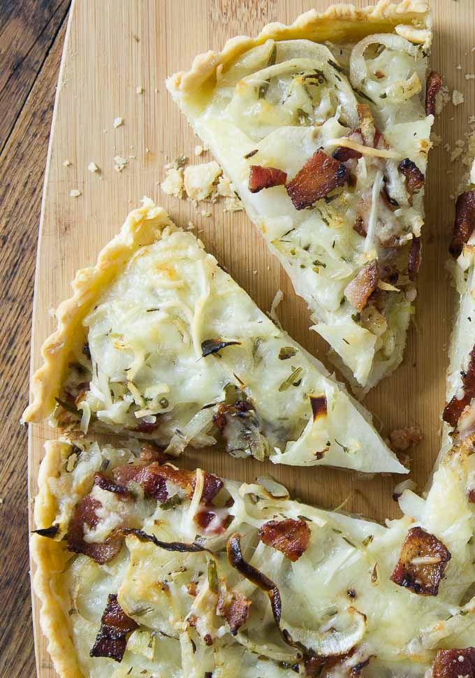 A close up of slices of potato bacon gruyere tart.