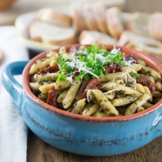 a blue bowl of penne pasta
