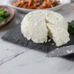 queso fresco on a black plate close up