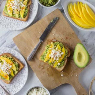 Try a new avocado toast recipe with Latin flair! Creamy avocados with tangy mango, salty queso fresco and a sprinkle of chili powder. The combination of flavors is incredible! | ethnicspoon.com