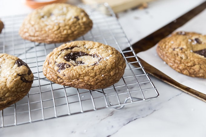 This is one big cookie you will need to dunk into some milk! You might like chocolate chip cookies but this English toffee, brown butter chocolate chunk cookie with sea salt is nothing short of amazing! Trust me this needs to be on your bucket list of things to bake. | ethnicspoon.com