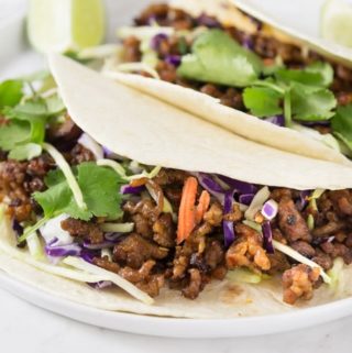 Here is a quick and easy weeknight meal for taco Tuesday made with ground pork. Spicy pork tacos with red cabbage slaw made with Vietnamese chili garlic sauce have a nice kick of heat you will love. The spicy flavors along with some ginger, brown sugar and cinnamon add a nice depth. These have the right amount of spice and a nice crunch too! | ethnicspoon.com