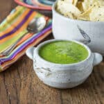 A photo of mango tomatillo salsa in a ceramic bowl.