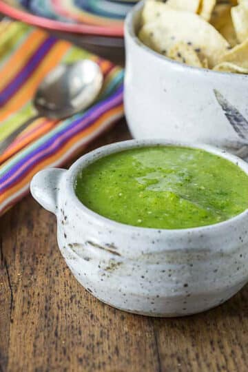 A photo of mango tomatillo salsa in a ceramic bowl.