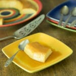 A photo of no bake flan on a yellow plate with a spoon.