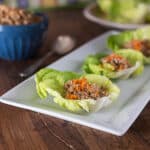 A photo of Thai lettuce wraps in a white plate.
