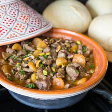 A photo of lamb tagine with apricots on a stovetop.