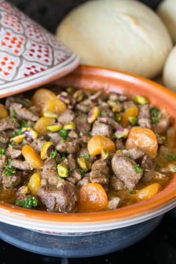 A photo of lamb tagine with apricots on a stovetop.