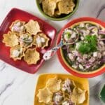 A red and yellow ceramic bowl with ceviche made from tilpaia.