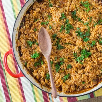 A photo of West African jollof rice in a red pan.
