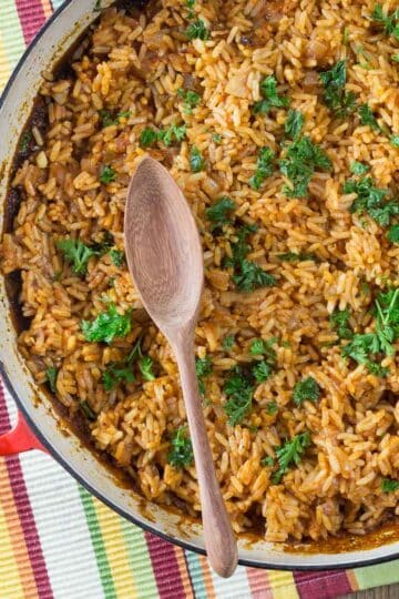 A photo of West African jollof rice in a red pan.