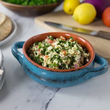 A ceramic bowl with tabouleh.