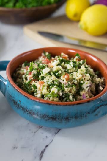 A ceramic bowl with tabouleh.