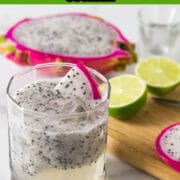 A photo of a dragonfruit lemongrass cocktail with limes on a cutting board in the background.