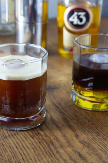 A photo of two carajillo cocktail, one poured in layers and another shaken.