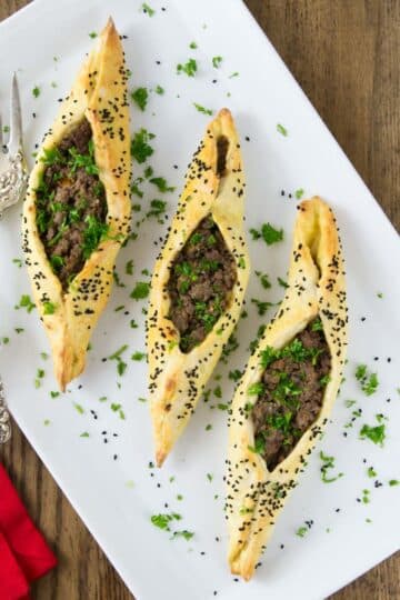 A white platter with Lebanese lamb fatayer.